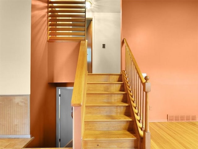 staircase with wood-type flooring