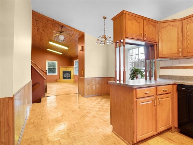 kitchen featuring lofted ceiling, wood ceiling, hanging light fixtures, kitchen peninsula, and ceiling fan with notable chandelier