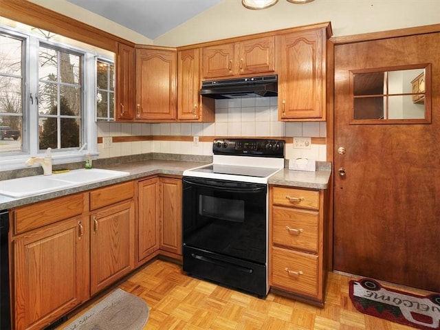 kitchen featuring light parquet flooring, vaulted ceiling, sink, and black appliances