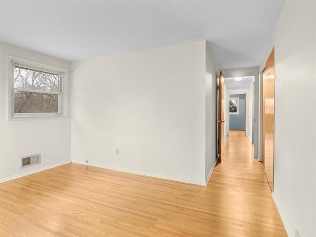 spare room featuring light wood-type flooring