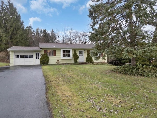 ranch-style house with a garage and a front lawn