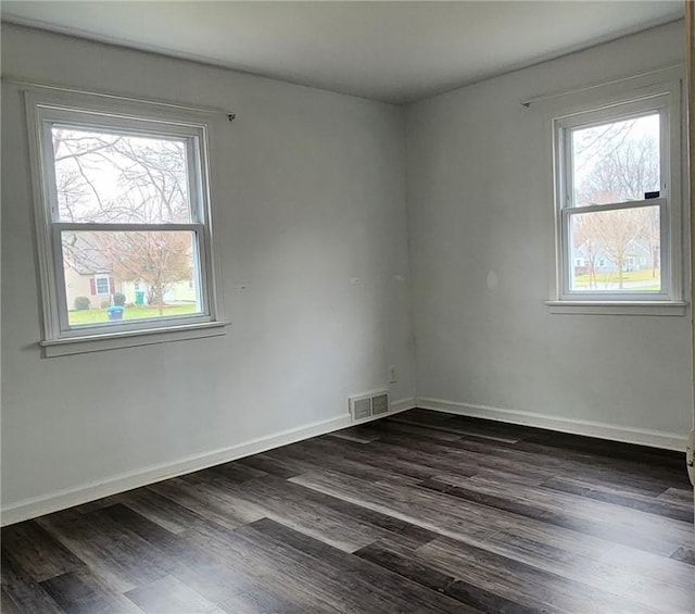 unfurnished room with dark hardwood / wood-style floors