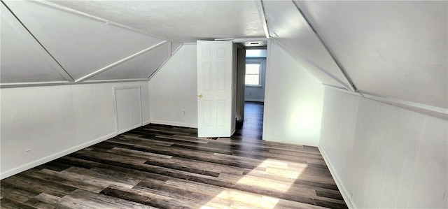 additional living space featuring lofted ceiling and dark hardwood / wood-style floors