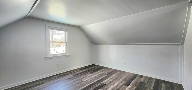 additional living space with vaulted ceiling and dark hardwood / wood-style floors