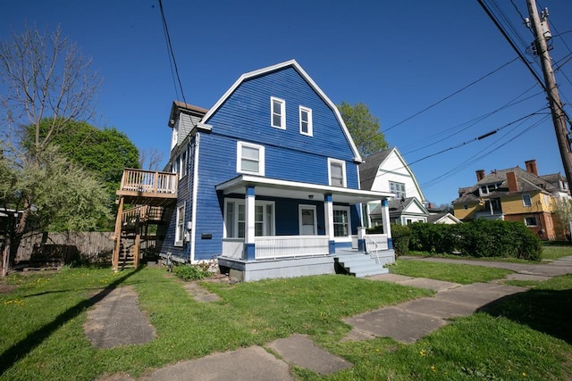 view of property with a front yard and covered porch