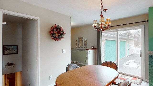 dining space with an inviting chandelier