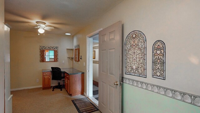 office with light colored carpet and ceiling fan