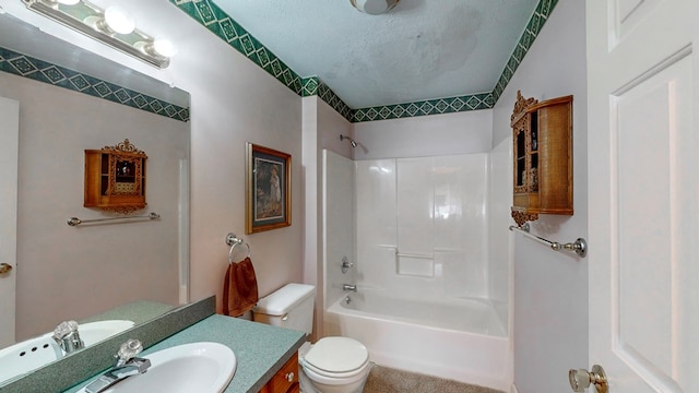 full bathroom with  shower combination, toilet, a textured ceiling, and vanity