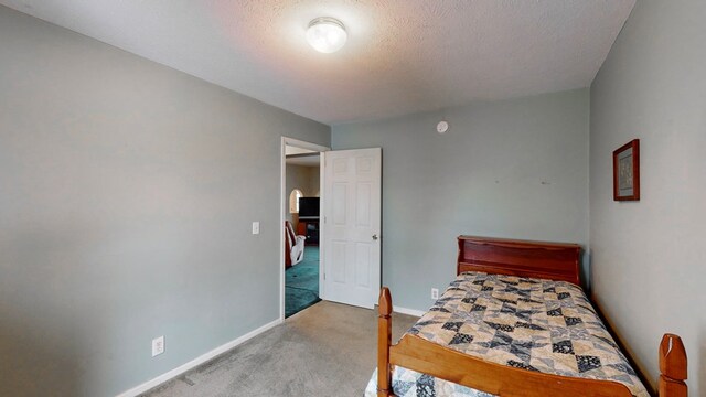 carpeted bedroom with a textured ceiling