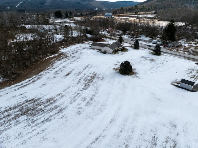 snowy aerial view with a mountain view