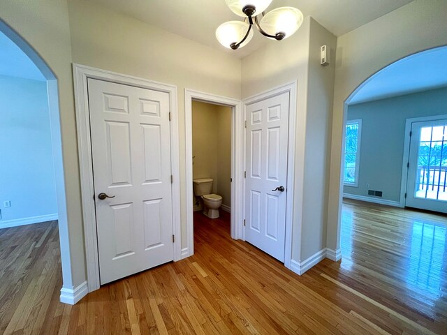 corridor with wood-type flooring