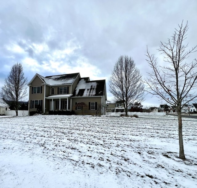 view of snow covered back of property