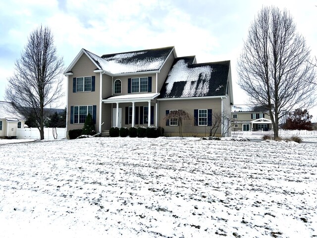 snow covered property with a porch