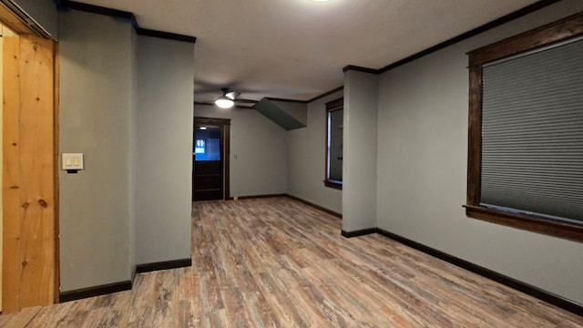 interior space with wood-type flooring, ornamental molding, and ceiling fan