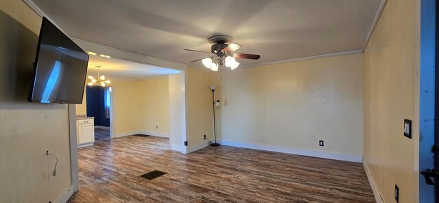 unfurnished room with crown molding, ceiling fan with notable chandelier, and hardwood / wood-style floors