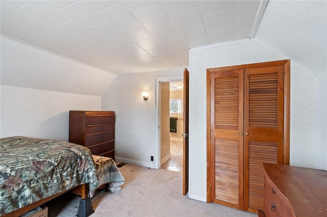 bedroom with vaulted ceiling and light colored carpet