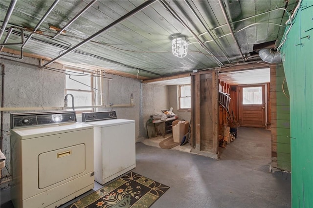 clothes washing area with plenty of natural light and independent washer and dryer