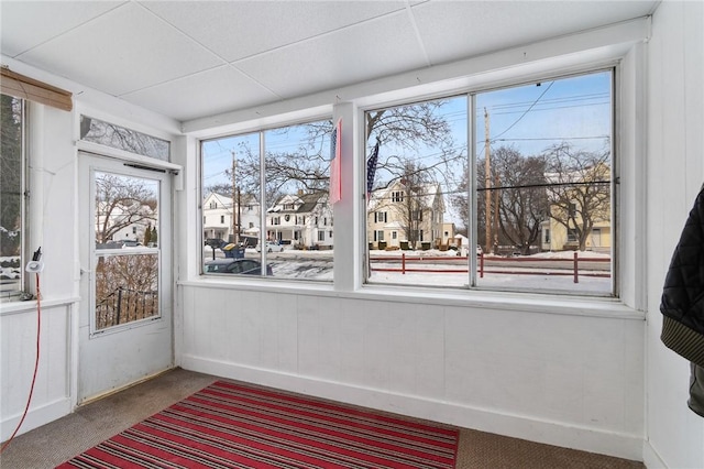 unfurnished sunroom featuring a paneled ceiling