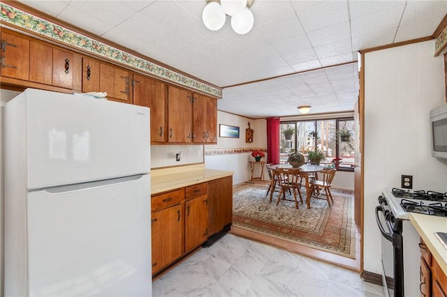 kitchen featuring white refrigerator and range with gas cooktop