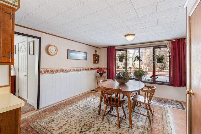 dining space featuring crown molding