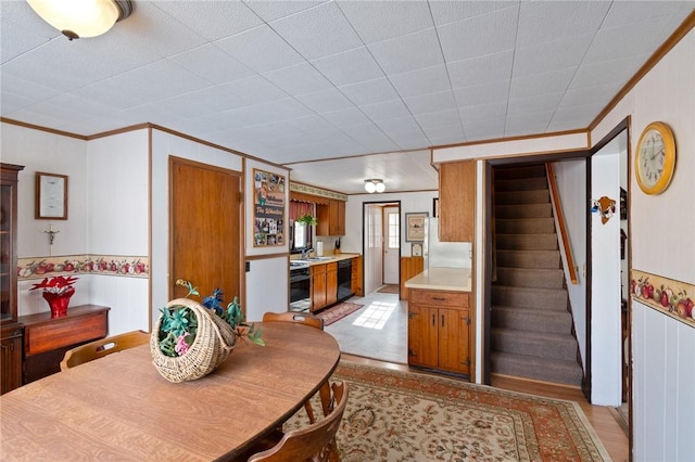 dining space featuring crown molding and sink