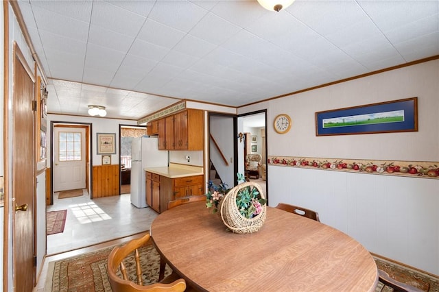 dining space featuring crown molding