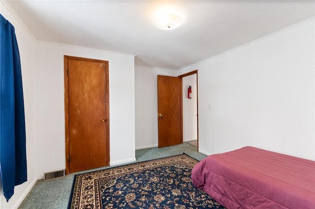 bedroom with ornamental molding and carpet flooring