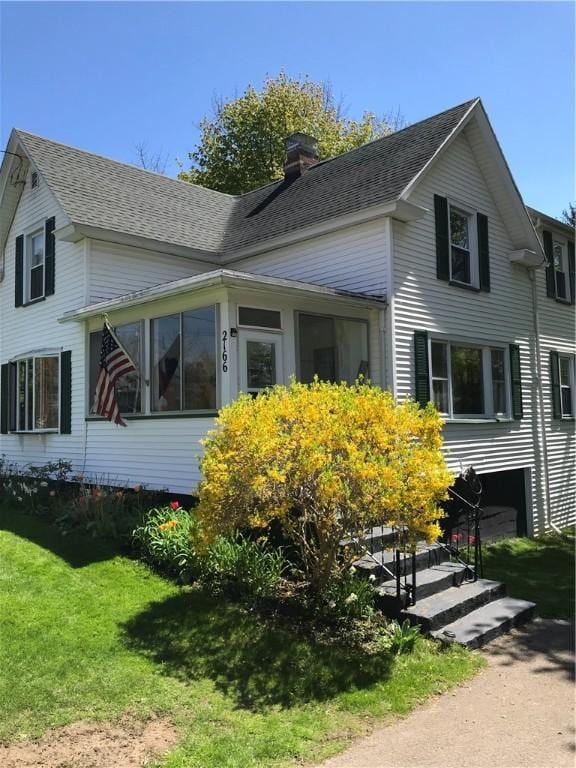 view of property exterior featuring a lawn