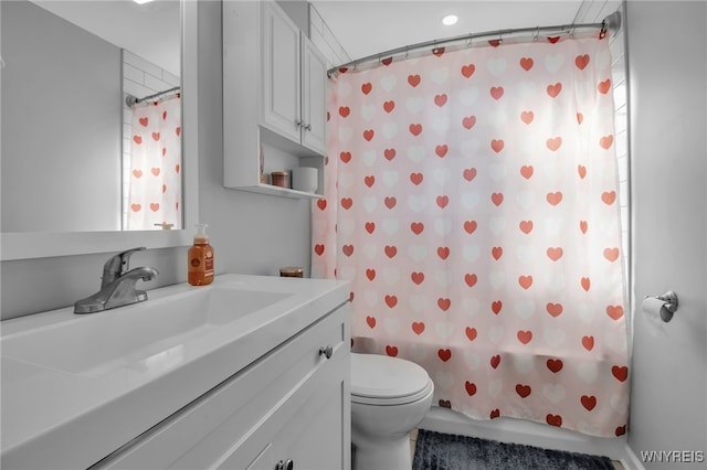 full bathroom with vanity, toilet, and shower / bath combo with shower curtain