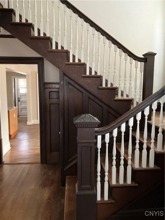 staircase with hardwood / wood-style floors