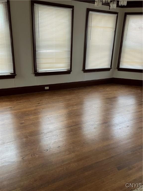 empty room with dark hardwood / wood-style flooring