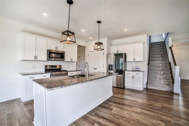 kitchen with white cabinetry, sink, an island with sink, and appliances with stainless steel finishes