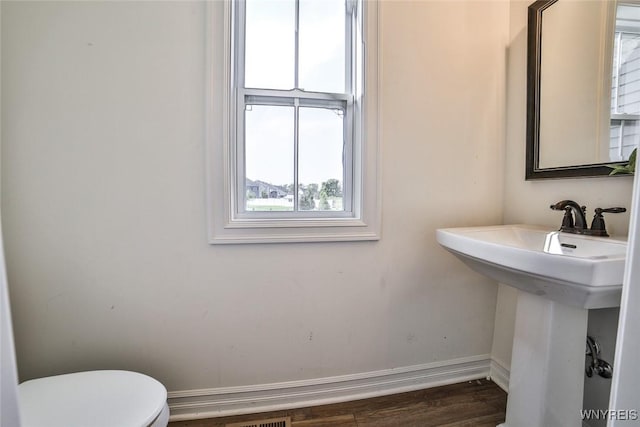 bathroom featuring sink, hardwood / wood-style floors, and toilet