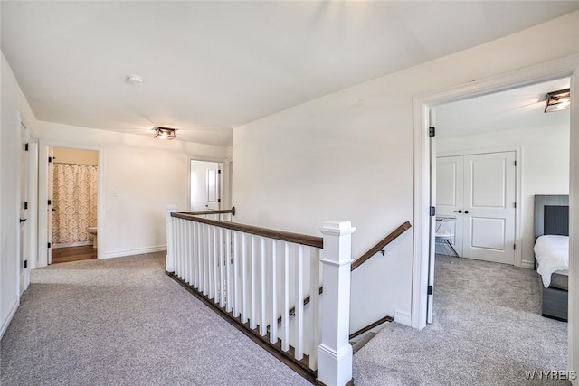 hallway featuring light carpet