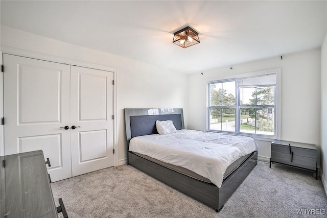 carpeted bedroom with a closet