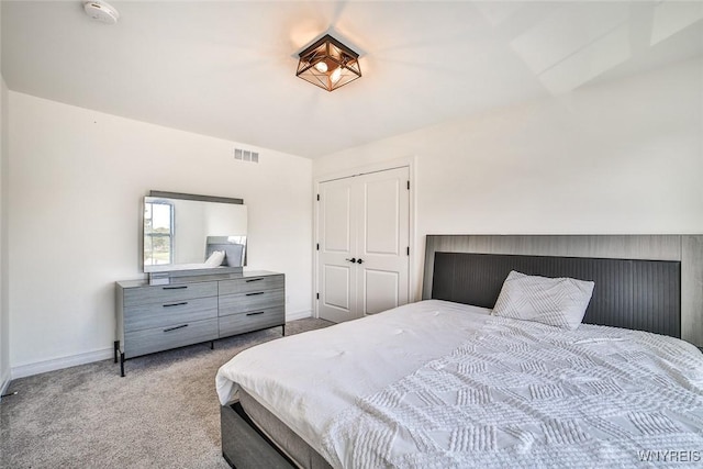 bedroom featuring light carpet and a closet