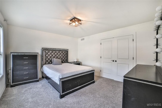 carpeted bedroom with a closet