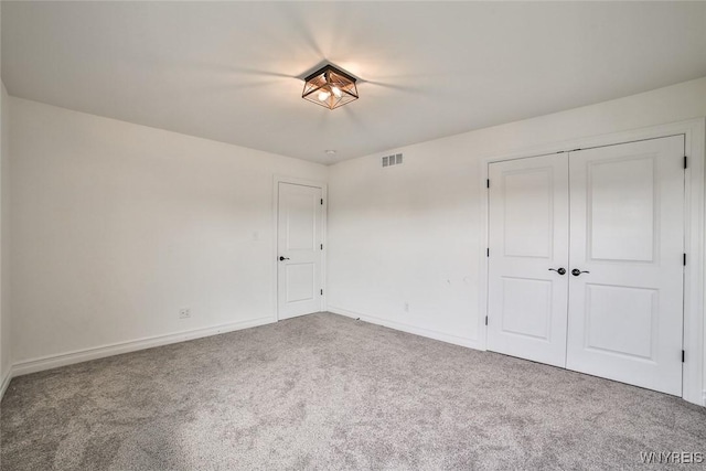 unfurnished bedroom with carpet floors and a closet