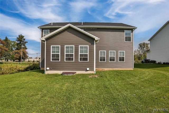 back of house featuring a lawn