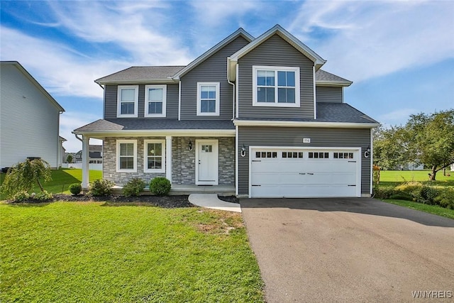 view of front of home featuring a garage, covered porch, and a front lawn