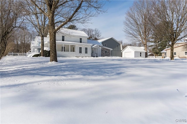 view of front facade with a garage and an outbuilding