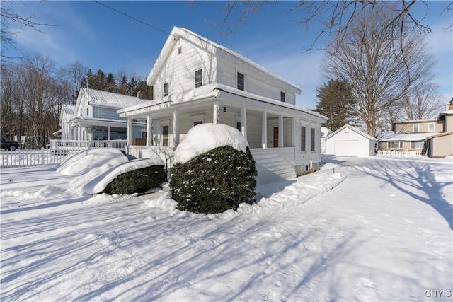 view of front of home with a garage, an outdoor structure, and a porch