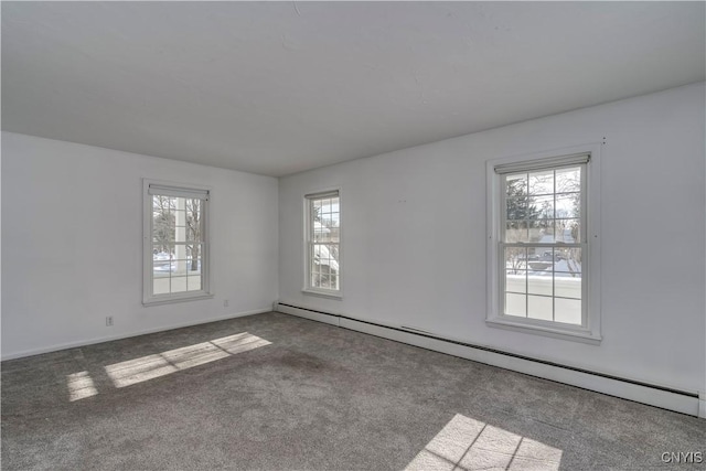 carpeted spare room featuring baseboard heating