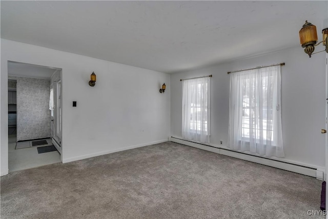 spare room with a baseboard radiator and light carpet