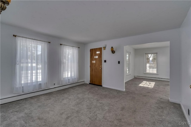 interior space with a baseboard radiator and light carpet