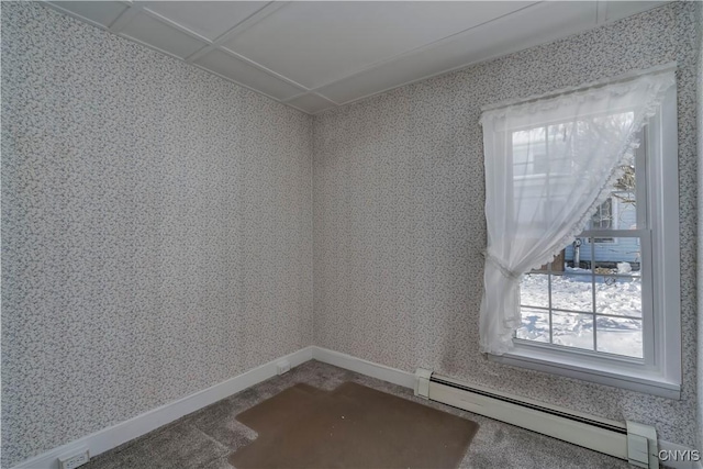 empty room featuring a baseboard radiator, carpet, and a wealth of natural light