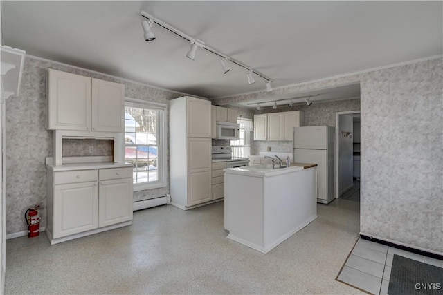 kitchen featuring sink, white cabinets, white appliances, and baseboard heating