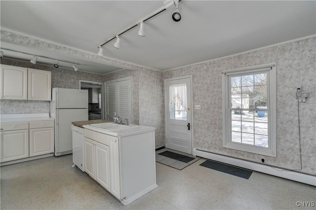 kitchen with white cabinetry, a baseboard radiator, sink, and white appliances