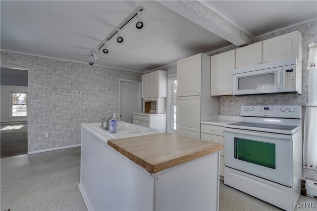 kitchen featuring a kitchen island, sink, white cabinets, track lighting, and white appliances