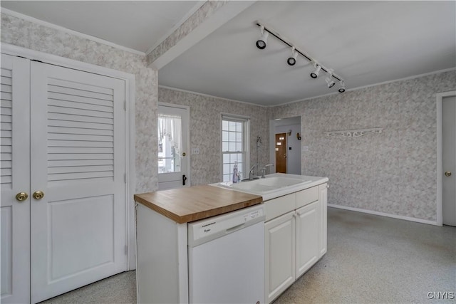 kitchen with rail lighting, butcher block countertops, sink, dishwasher, and white cabinets